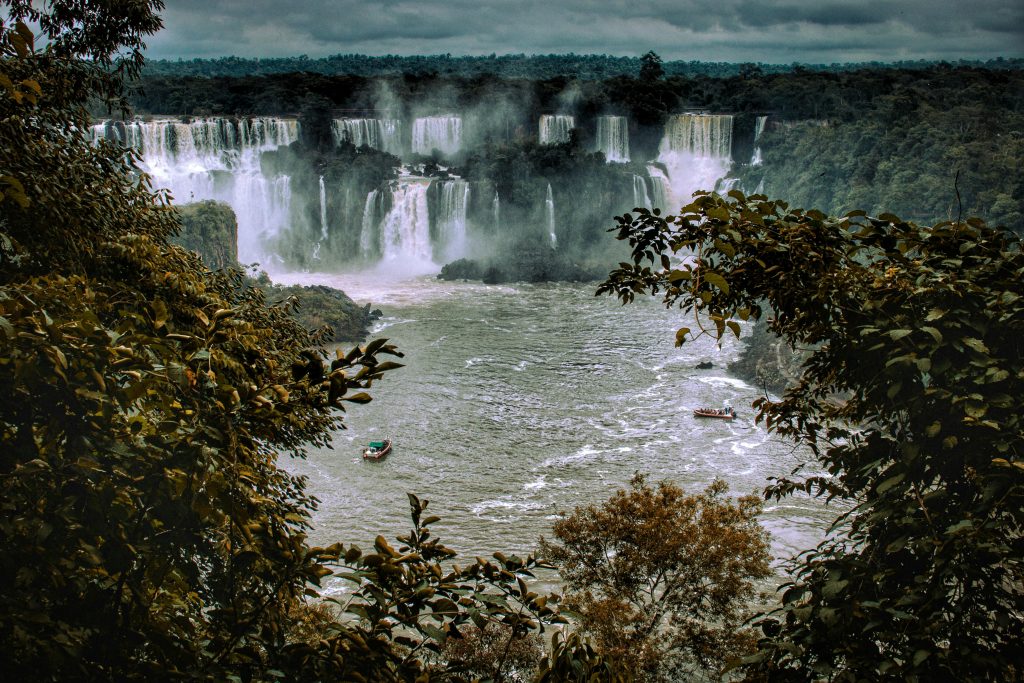Explore the stunning Iguazu Falls surrounded by lush tropical forest.